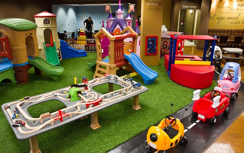 the chidren play area with slide, trampoline, toy train table, and so on